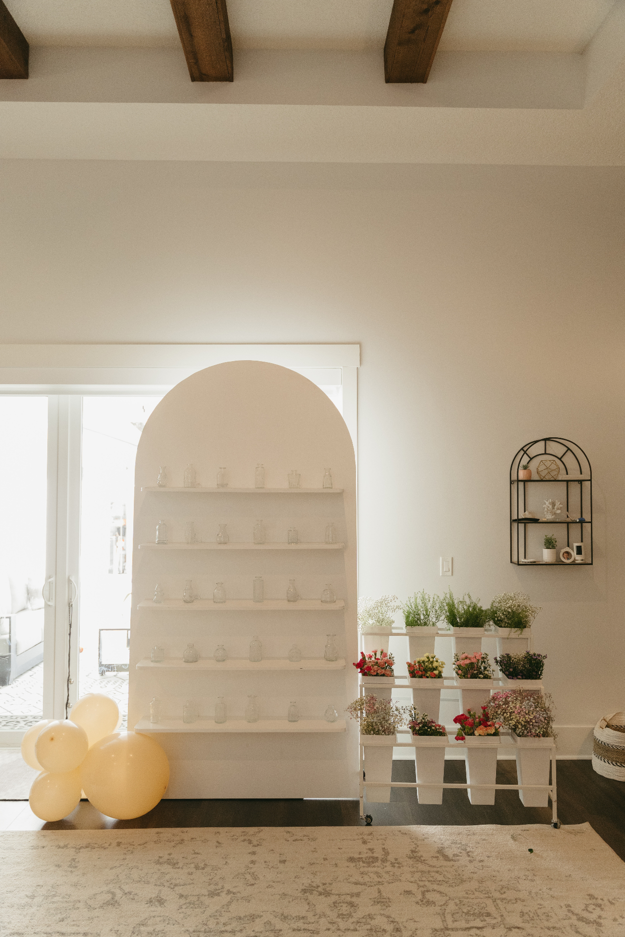 White arched shelf wall rental setup with decor