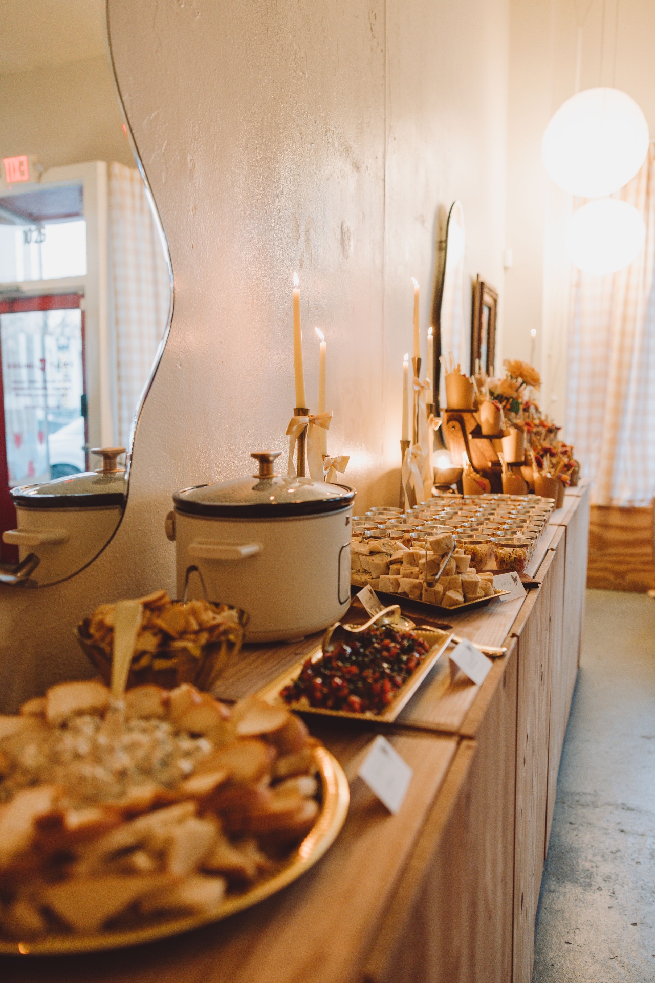 Elegant event buffet spread with appetizers, candles and styled serving pieces